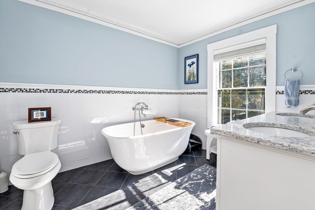 62 Old River Place Dedham, MA 02026 - Photo 22 of 39 a spacious bathroom with a granite countertop sink and a mirror