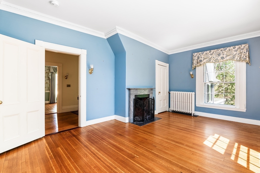 62 Old River Place Dedham, MA 02026 - Photo 24 of 39 a view of empty room with a fireplace and wooden floor