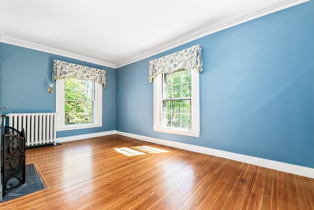 62 Old River Place Dedham, MA 02026 - Photo 25 of 39 a view of an empty room with wooden floor and a window