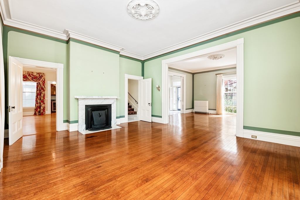 62 Old River Place Dedham, MA 02026 - Photo 4 of 39 a view of a livingroom with wooden floor and a fireplace
