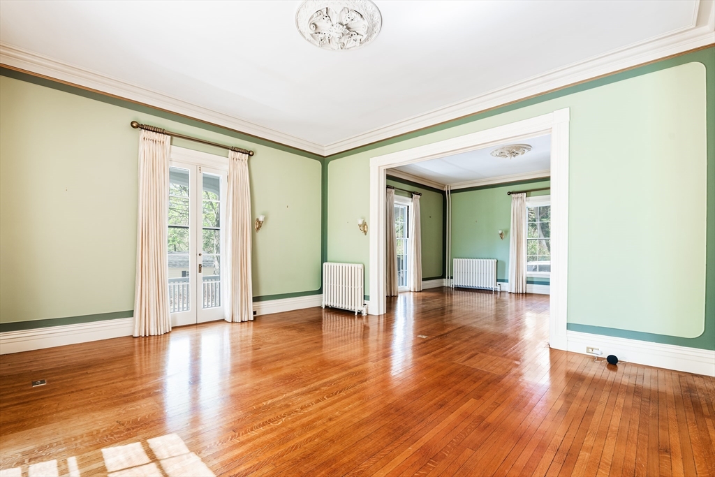 62 Old River Place Dedham, MA 02026 - Photo 6 of 39 a view of empty room with wooden floor and fan