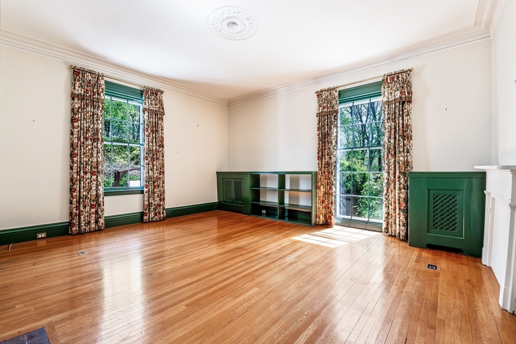 62 Old River Place Dedham, MA 02026 - Photo 7 of 39 a view of an empty room with wooden floor and a window