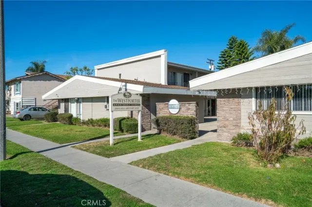 a view of a house with a yard and sitting area