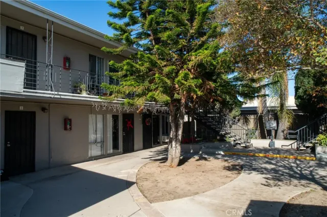a view of a house with a tree in front of it