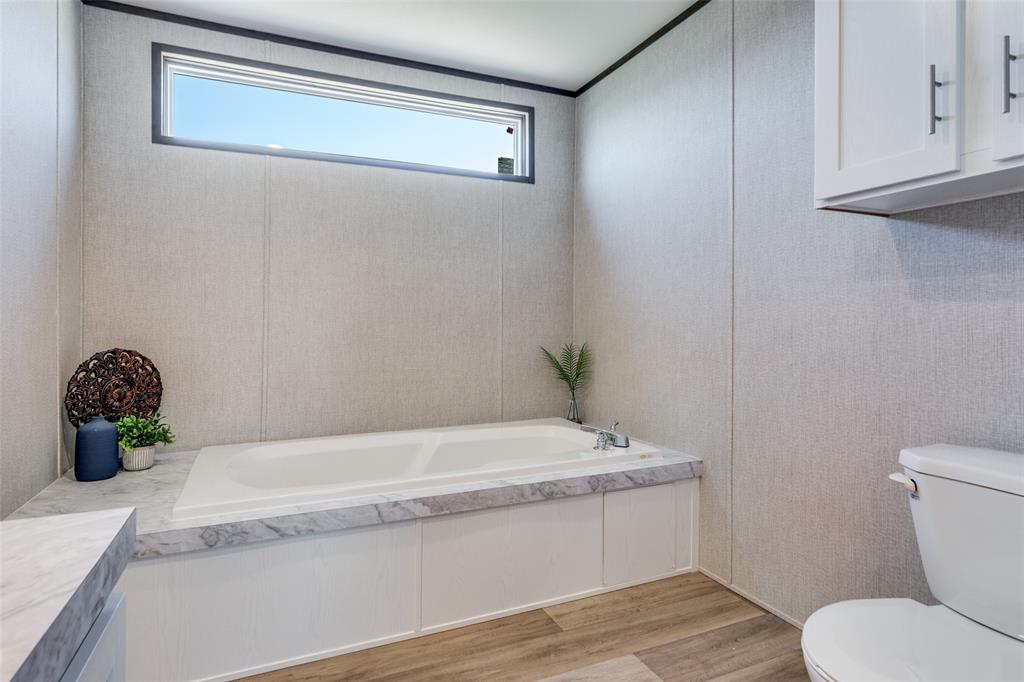 175 Cedar Drive Azle, TX 76020 - Photo 20 of 25 a bathroom with a granite countertop bathtub and sink