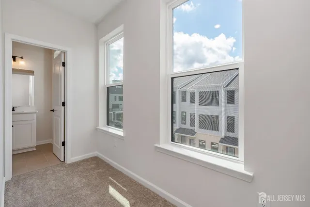 a spacious bathroom with double sink and mirror