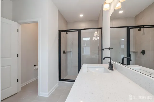 a bathroom with a glass shower door