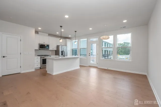a view of kitchen with kitchen island and stainless steel appliances
