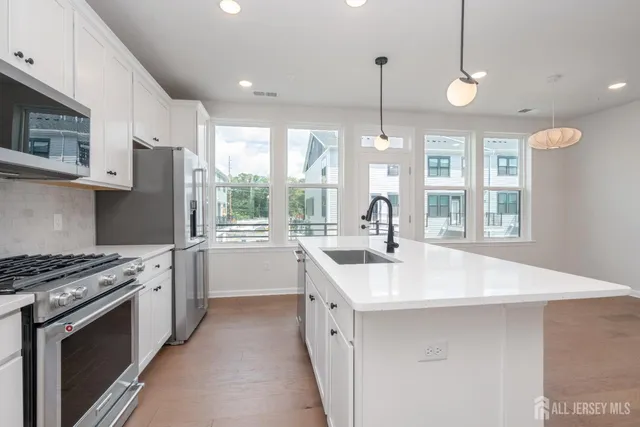 a kitchen with a sink stove and cabinets