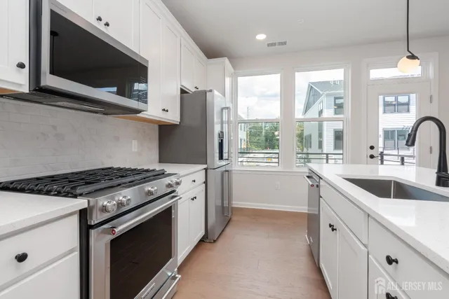 a kitchen with a sink stove and microwave
