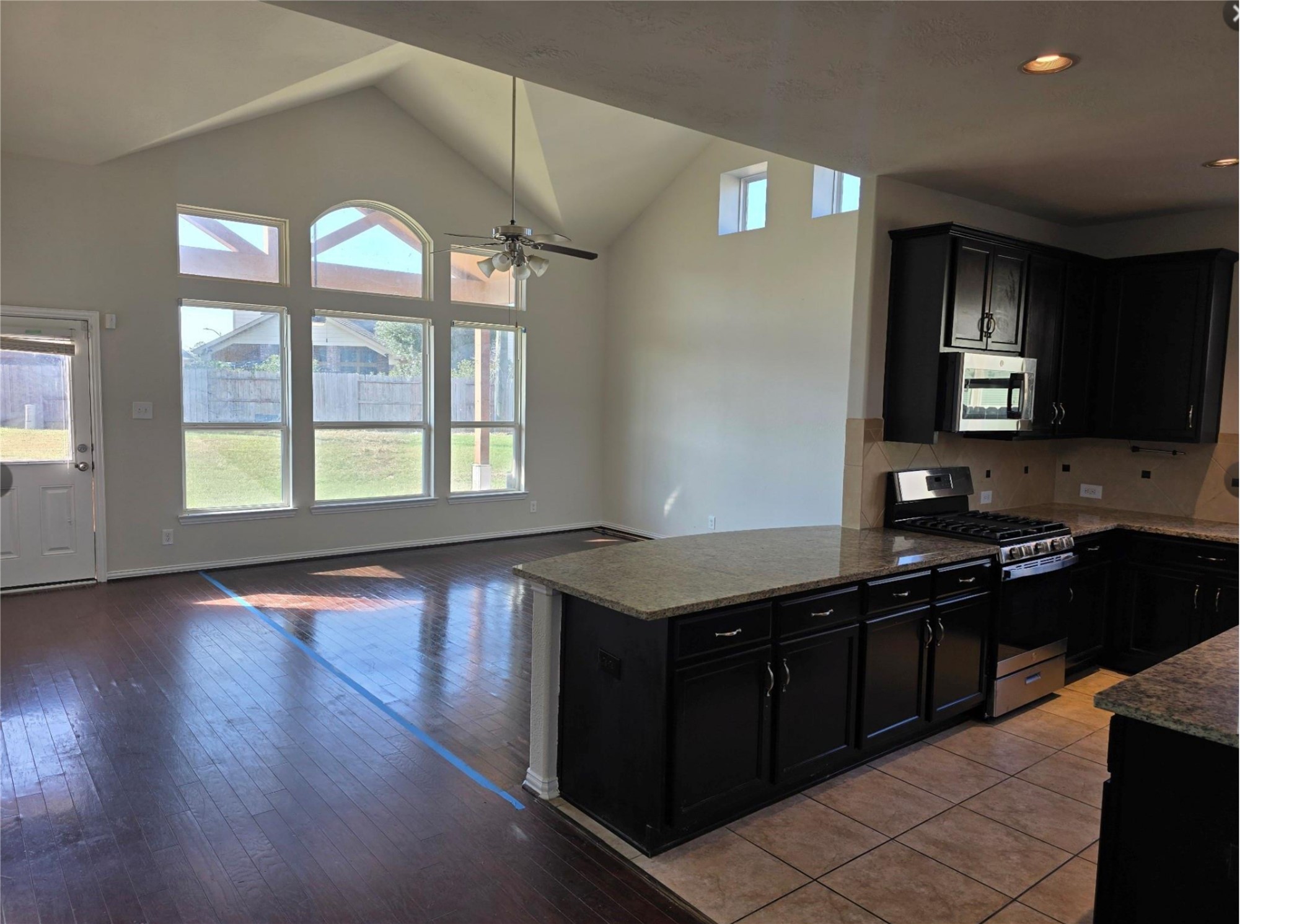 9702 Layton Ridge Drive Humble, TX 77396 - Photo 21 of 21 a kitchen with a stove a sink and a microwave
