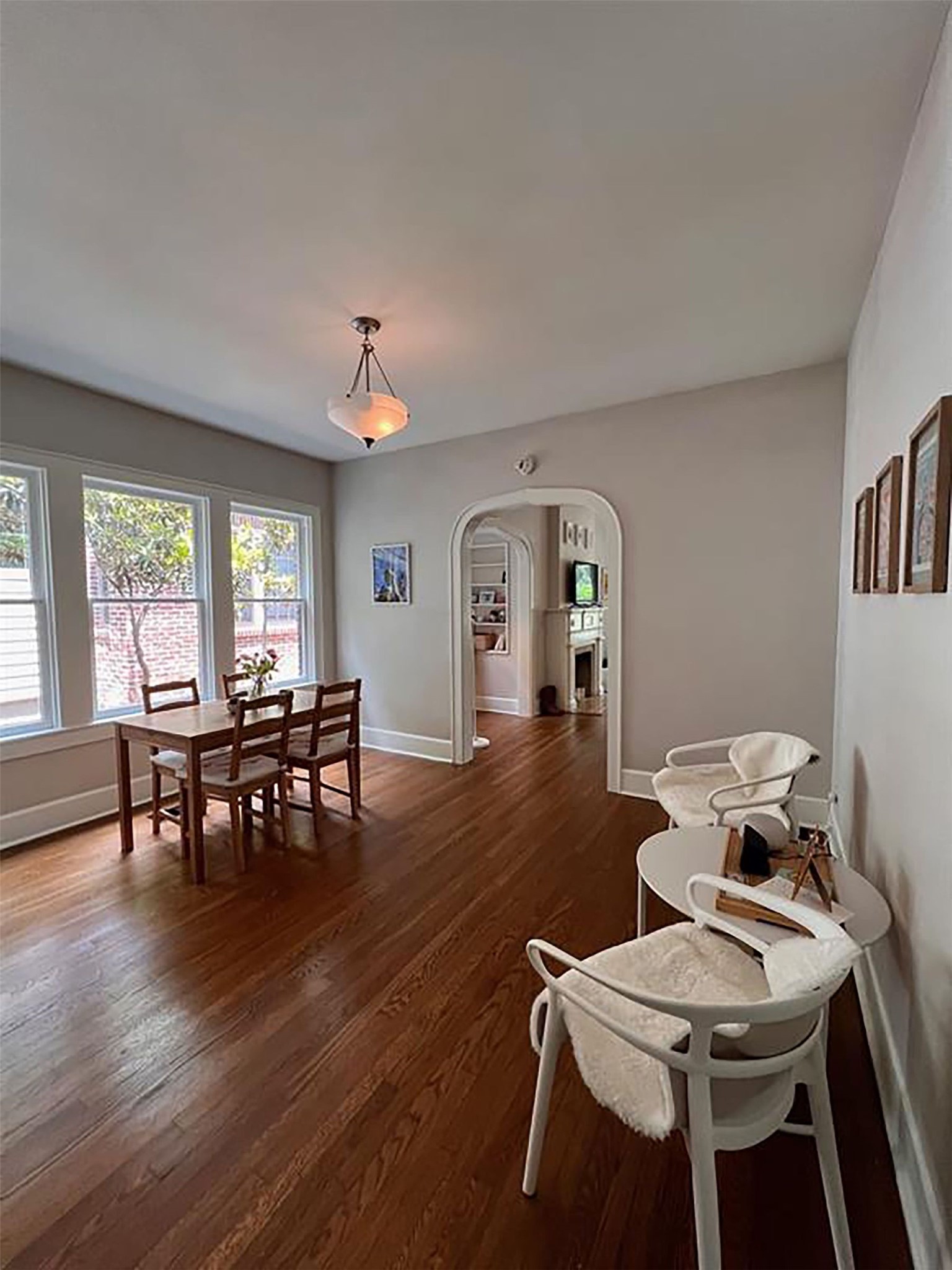 609 Texas Austin, TX 78705 - Photo 10 of 18 Dining room featuring arched walkways and dark wood finished floors.