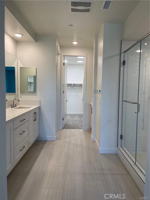 3326 Doheny Way Dana Point, CA 92629 - Photo 13 of 46 a bathroom with a double vanity sink a mirror and a shower