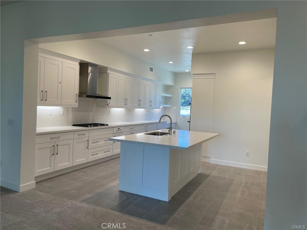 3326 Doheny Way Dana Point, CA 92629 - Photo 6 of 46 a kitchen with kitchen island a sink stainless steel appliances and cabinets