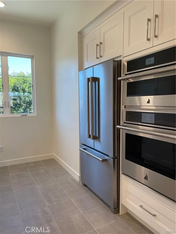 3326 Doheny Way Dana Point, CA 92629 - Photo 9 of 46 a kitchen with granite countertop white cabinets and stainless steel appliances