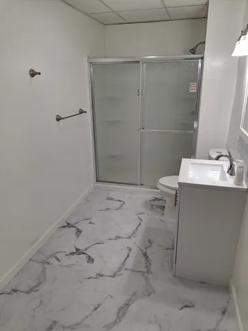a bathroom with a sink toilet and shower