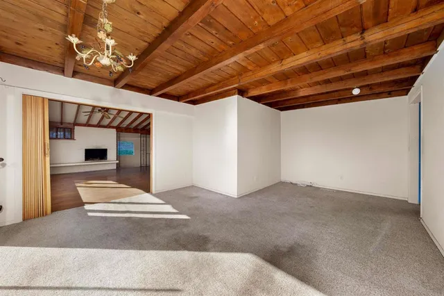 a view of a hallway with wooden floor and a ceiling fan