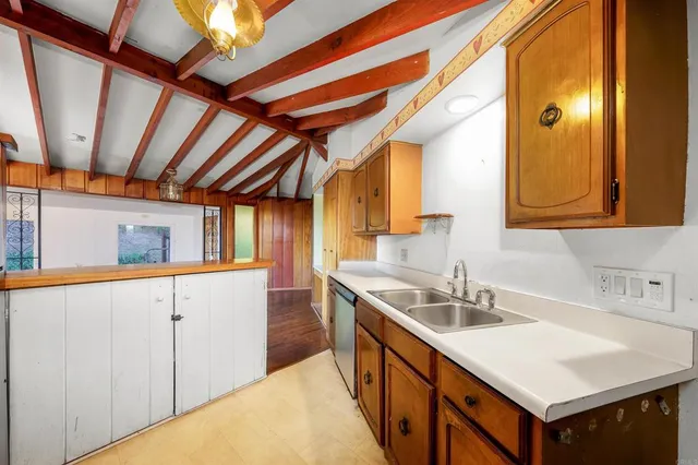 a kitchen with sink cabinets and a wooden floor