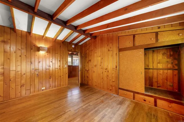 a view of hallway with stairs and wooden floor