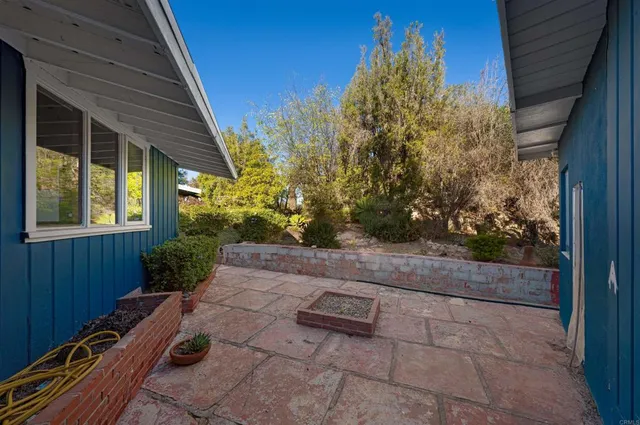 a view of backyard with plants and outdoor seating