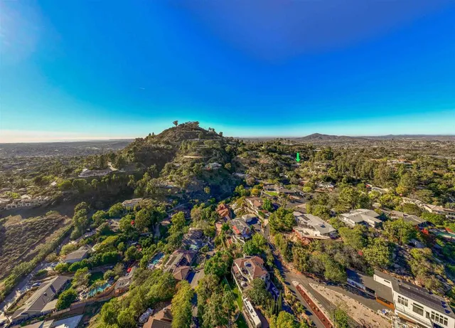 an aerial view of residential building and trees around