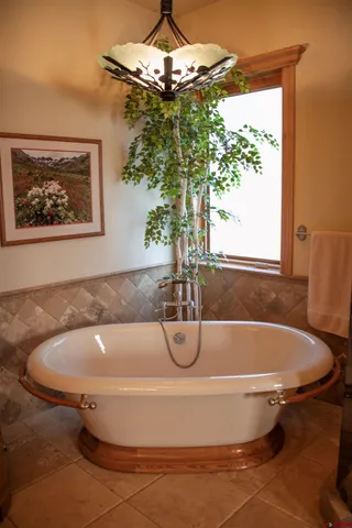 a bath tub sitting in a bathroom next to a window