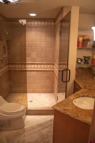 a bathroom with a sink toilet and shower