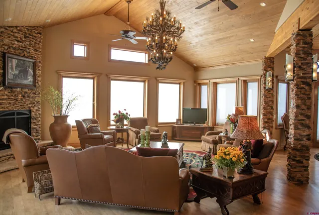 a living room with fireplace furniture and a large window