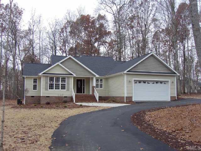 783 Oaks Lane Road Timberlake, NC 27583 - Photo 1 of 1 a front view of a house with a yard and garage