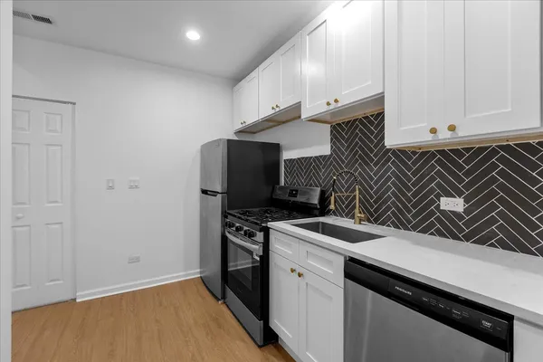 a kitchen with a sink and cabinets