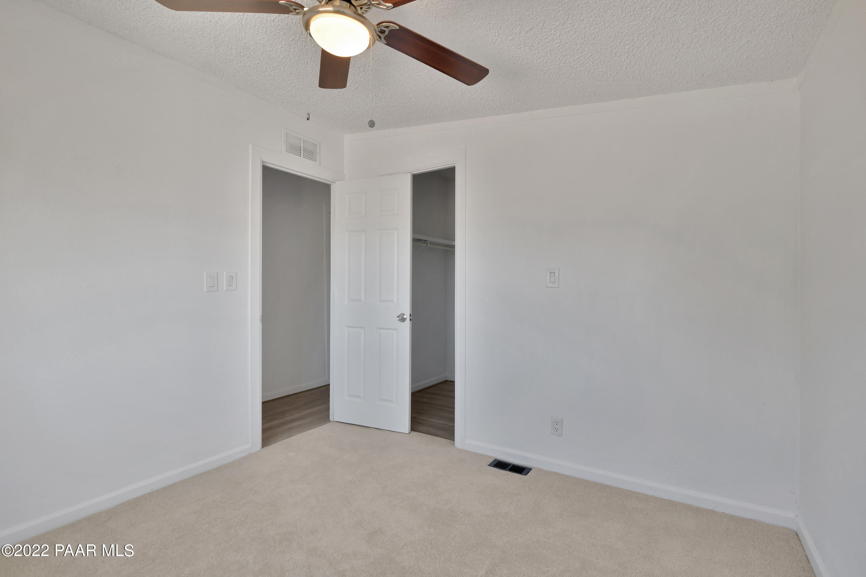 4515 Quail Hollow Road Rimrock, AZ 86335 - Photo 16 of 33 an empty room with a ceiling fan and carpet