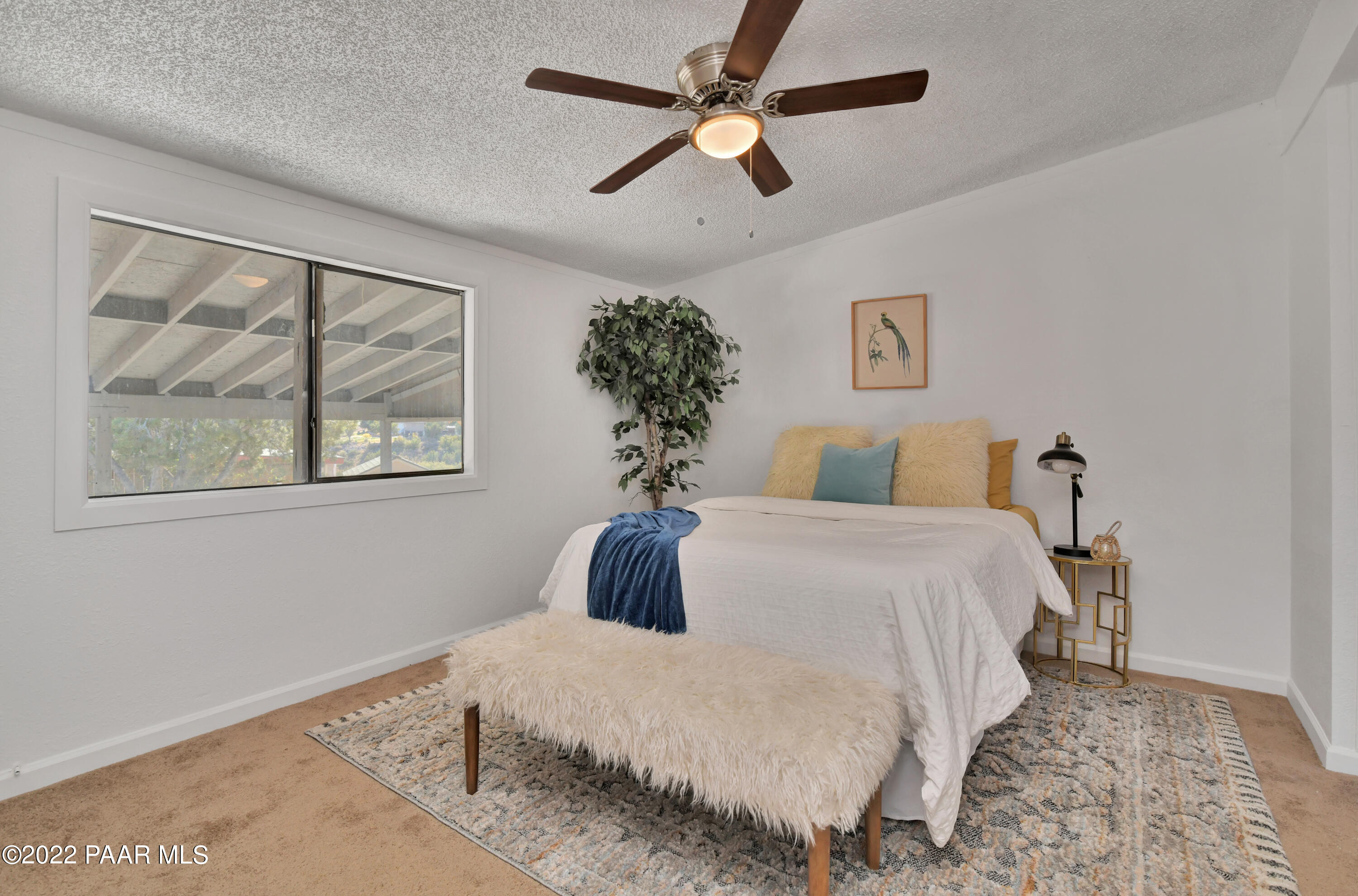 4515 Quail Hollow Road Rimrock, AZ 86335 - Photo 17 of 33 a bedroom with a bed and a painting on the wall