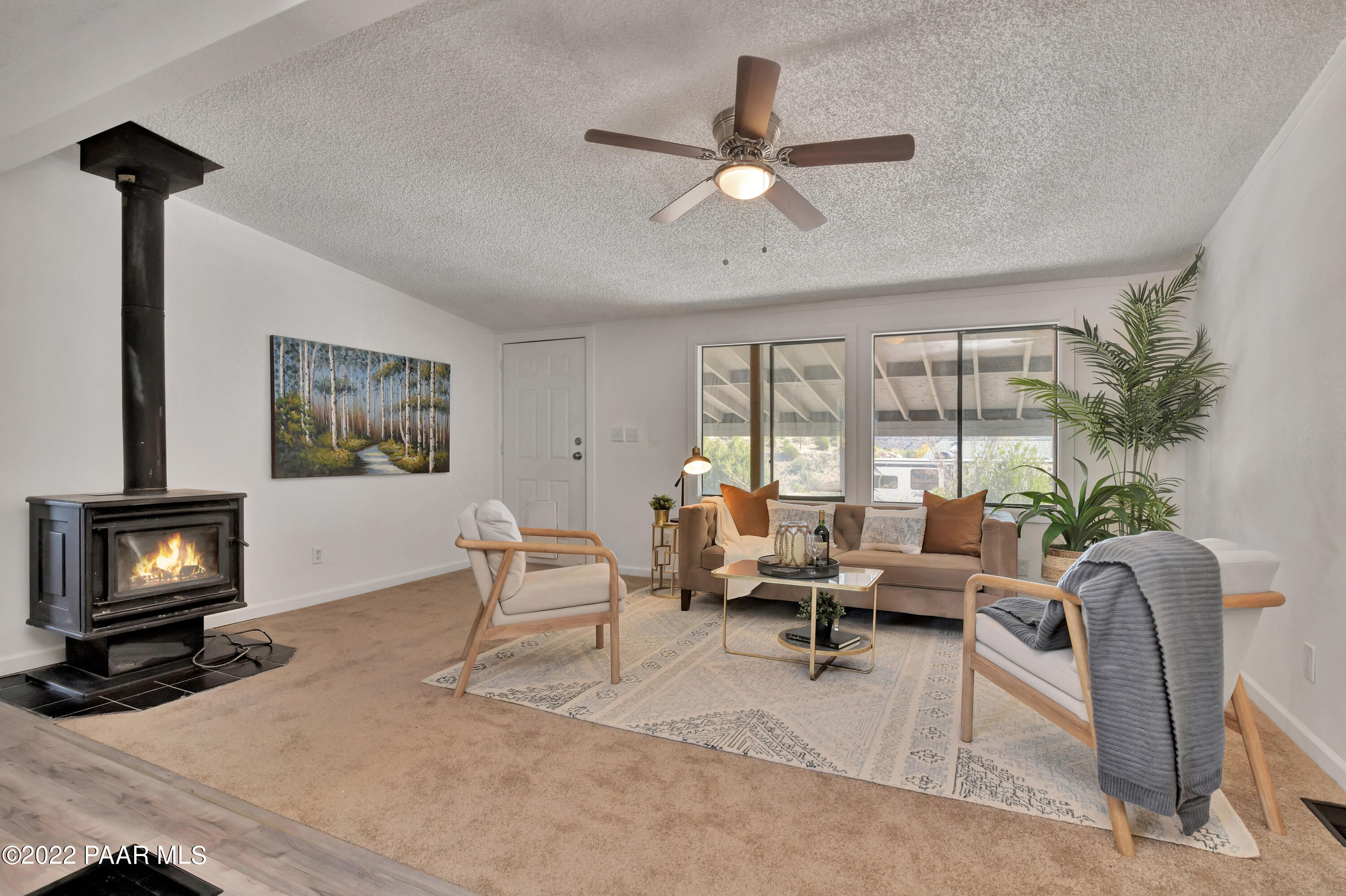 4515 Quail Hollow Road Rimrock, AZ 86335 - Photo 6 of 33 a living room with furniture a fireplace and a flat screen tv