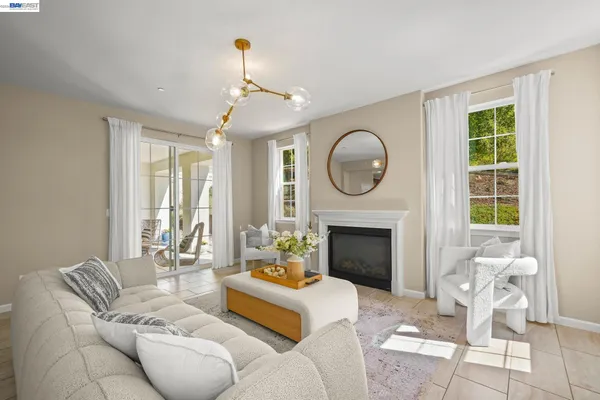 a living room with furniture and a floor to ceiling window