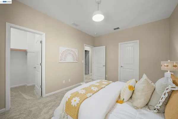 a bedroom with a bed and a large window