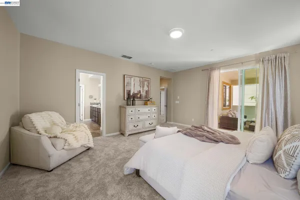 a living room with furniture a fireplace and a floor to ceiling window
