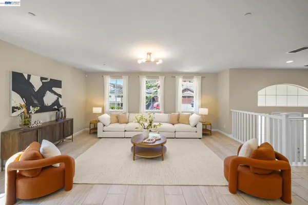a kitchen with stainless steel appliances kitchen island granite countertop a sink a stove a refrigerator and a dining table with wooden floor