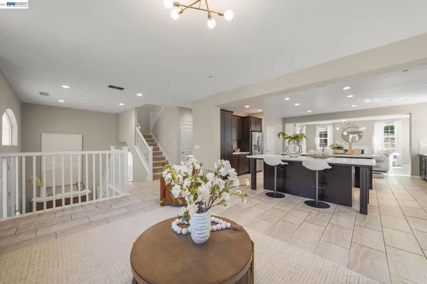 a kitchen with metallic refrigerator freezer and a sink