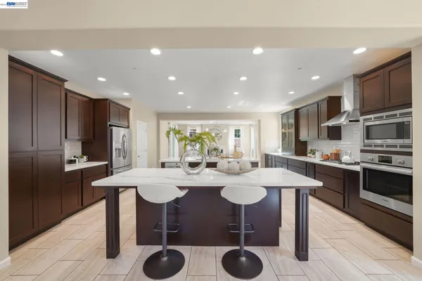 a kitchen with stainless steel appliances a sink and a refrigerator