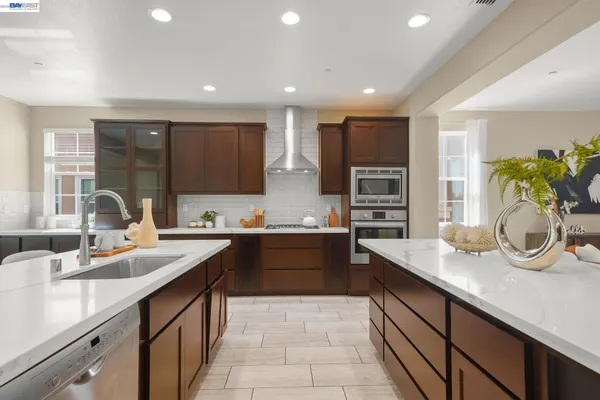 a dining room with furniture a large window and kitchen view