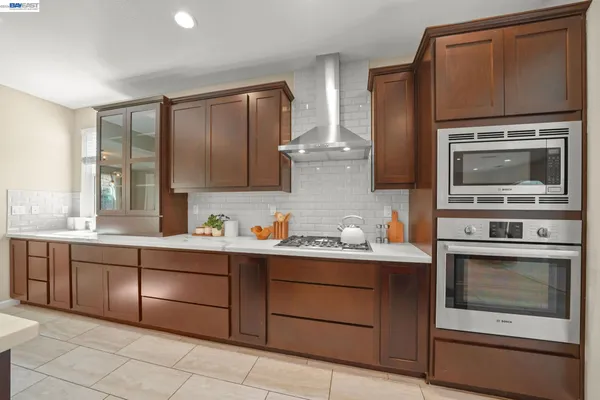 a living room with furniture a fireplace and a chandelier