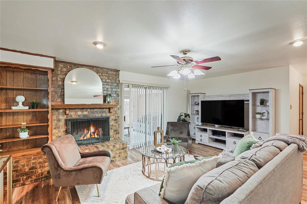 1203 Springbrook Circle DeSoto, TX 75115 - Photo 11 of 27 Living room with wood finished floors, a fireplace, and a ceiling fan