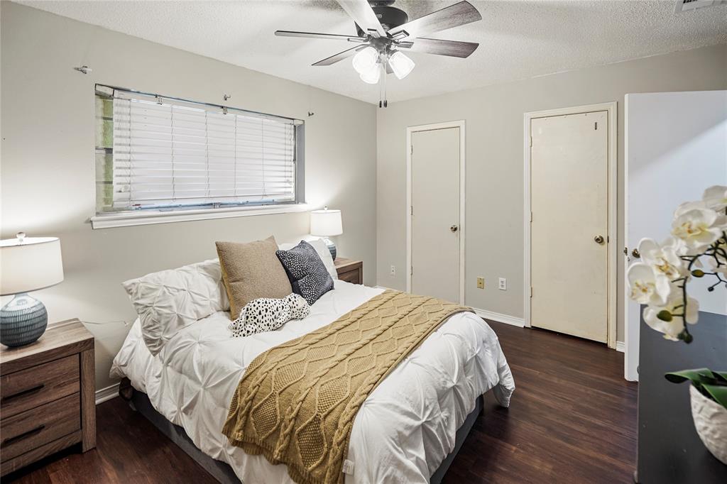 1203 Springbrook Circle DeSoto, TX 75115 - Photo 16 of 27 Bedroom with a textured ceiling, dark wood-style floors, and a ceiling fan