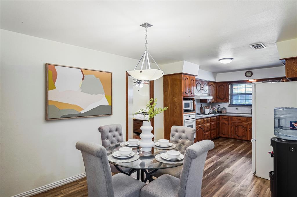 1203 Springbrook Circle DeSoto, TX 75115 - Photo 17 of 27 Dining room featuring dark wood-style flooring and baseboards