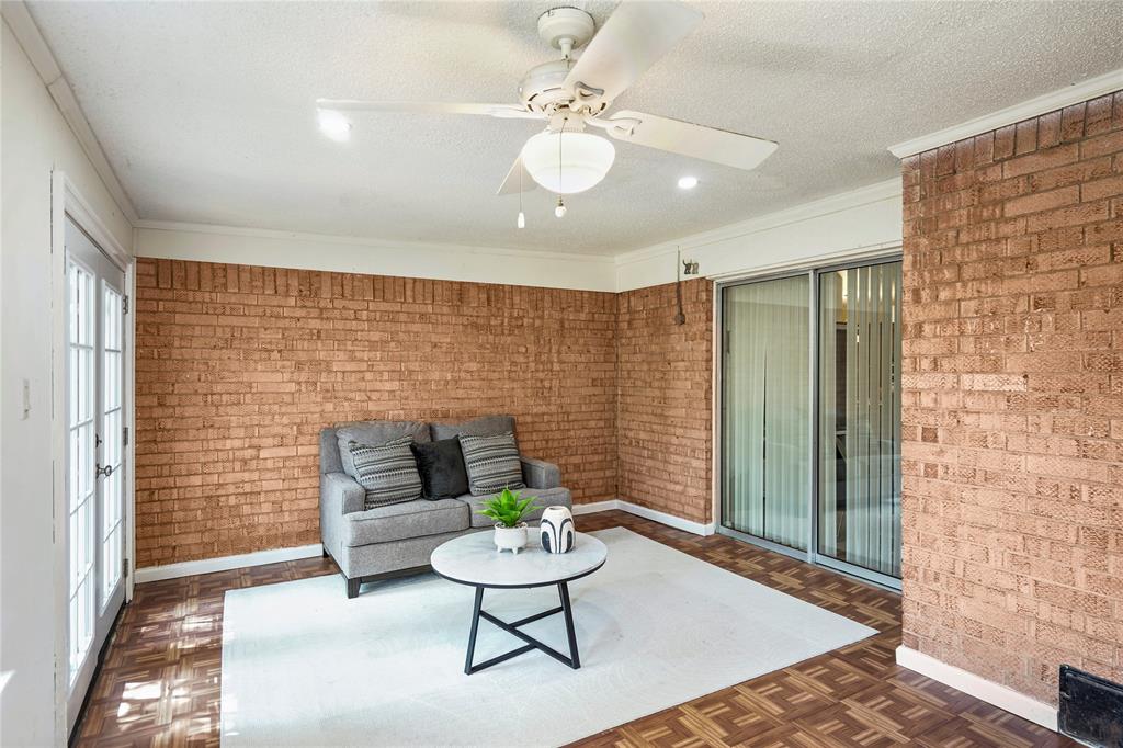 1203 Springbrook Circle DeSoto, TX 75115 - Photo 23 of 27 Unfurnished room with brick wall, crown molding, a textured ceiling, and ceiling fan