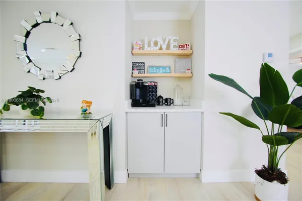 a view of cabinets chair and potted plant