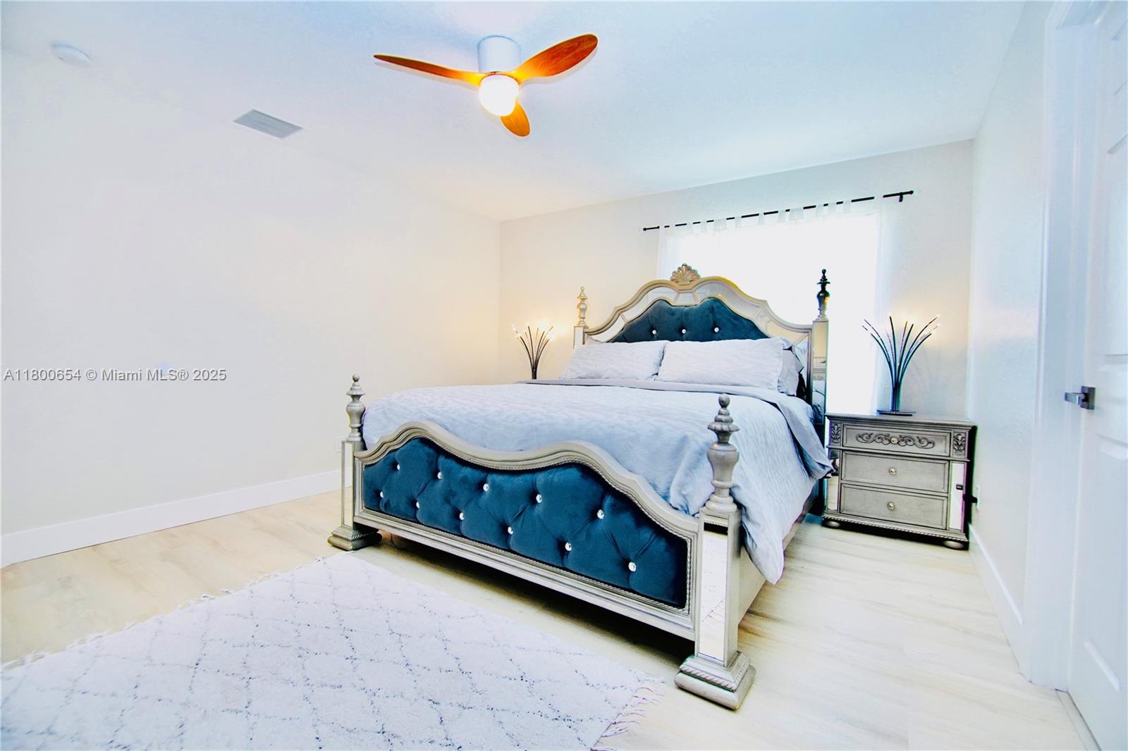 244 Northwest 6th Avenue, Unit 244 Delray Beach, FL 33444 - Photo 15 of 35 a bedroom with a bed and a chandelier