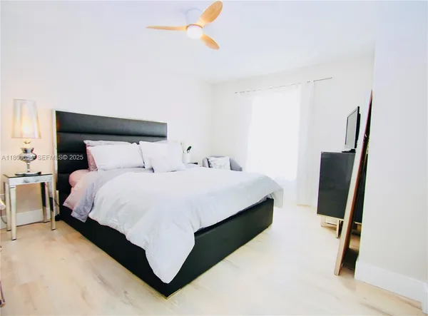 a bedroom with a bed and dresser