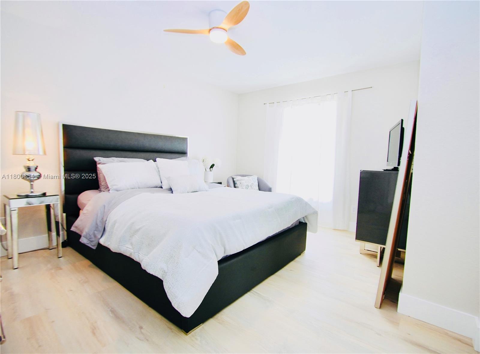 244 Northwest 6th Avenue, Unit 244 Delray Beach, FL 33444 - Photo 19 of 35 a bedroom with a bed and dresser