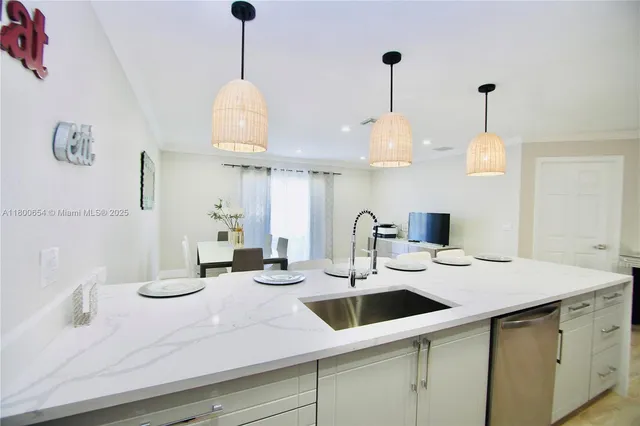 a kitchen with a sink and a chandelier
